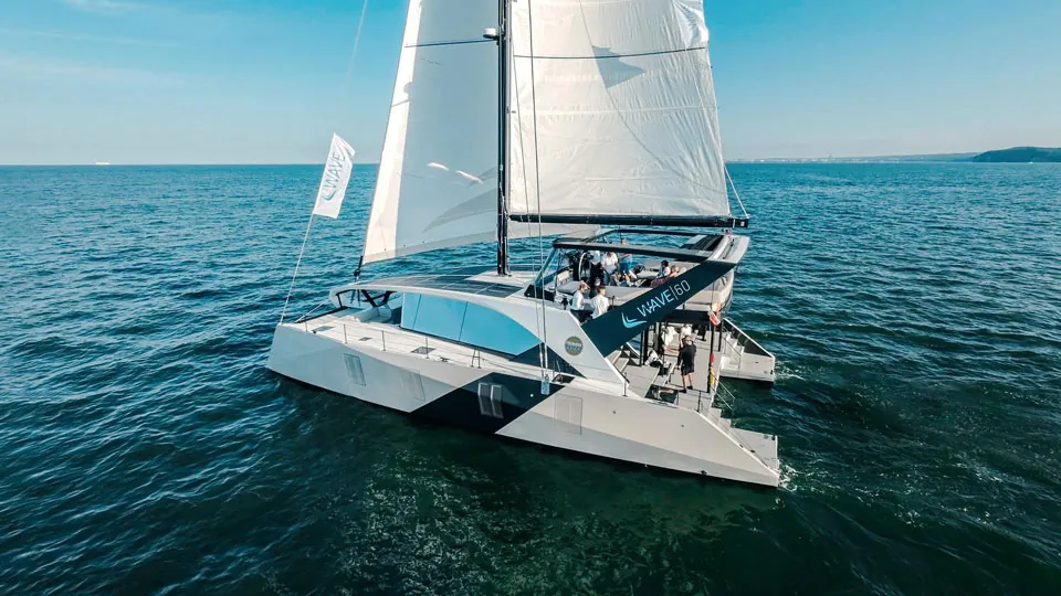 Wave 60 sailing catamaran underway